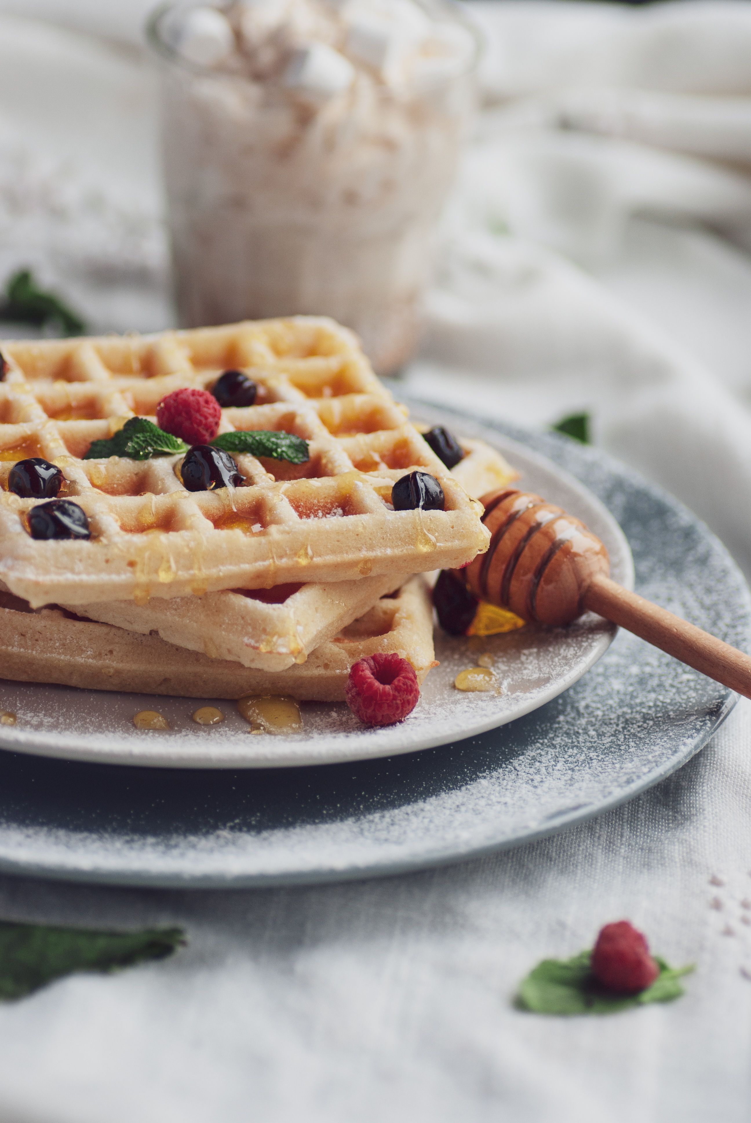 Stack of Wafflenis waffles drizzled with honey and berries